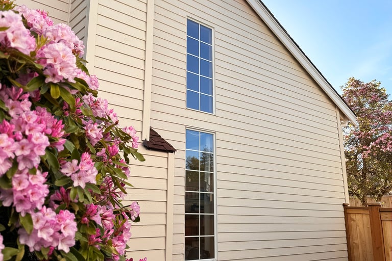 Two-story home with cream siding and brown roof