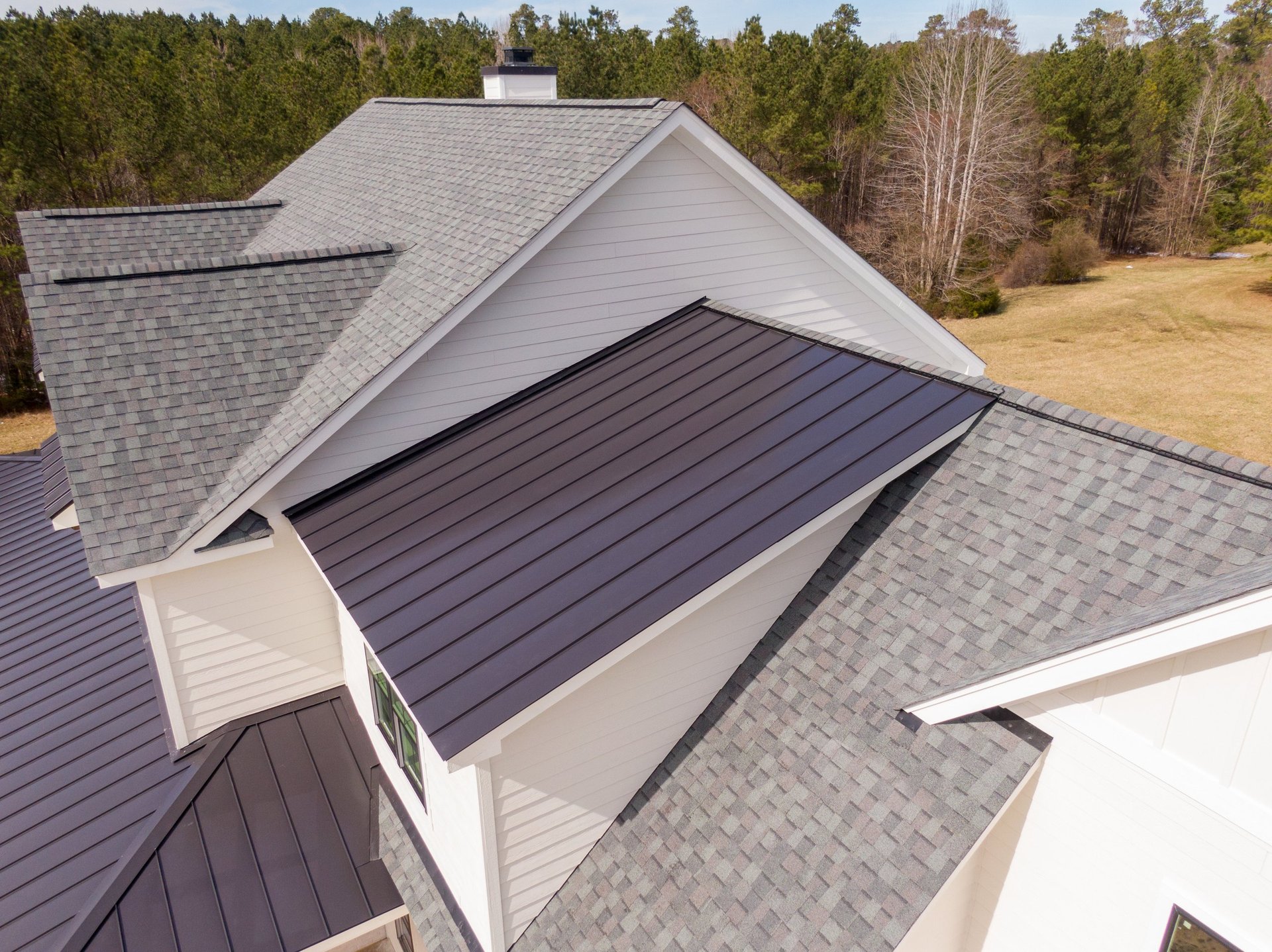 Custom residential home with mixed roofing materials